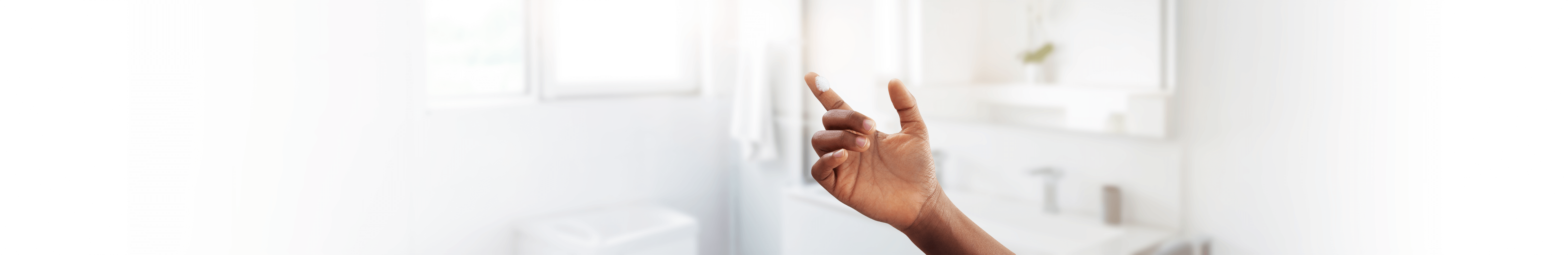 Hand with small pile of ZORYVE foam on finger